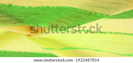 Silk fabric, large yellow-green stripes separated by a strip of emerald gold, pattern background texture, ornament