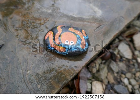 Kindness rock with cute painted cartoon octopus