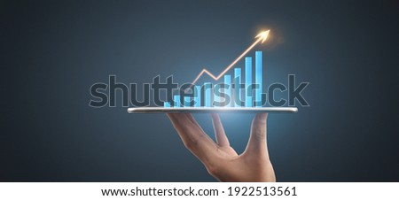 Businessman plan graph growth and increase of chart positive indicators in his business,tablet in hand Royalty-Free Stock Photo #1922513561