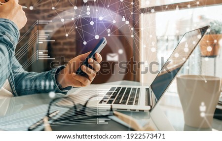Close-up photo of male hands with laptop. Man working remotely at home. Concept of networking or remote work. Global business network. Royalty-Free Stock Photo #1922573471