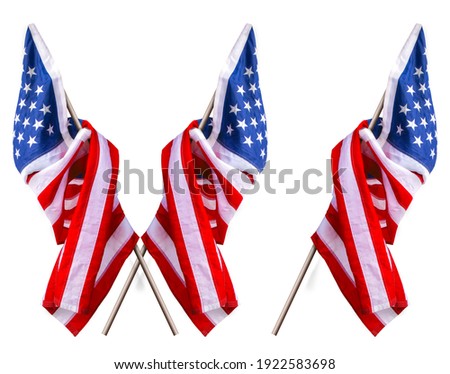 the beautiful star striped flag of the United States of America hangs on a flagpole in two variations one and crossed 