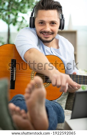 man checking sheet music on tablet computer