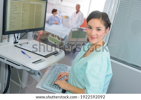 happy female doctor at the computer in hospital room
