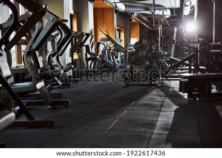 No people photo of an empty gym well-equipped with all kinds of machines Royalty-Free Stock Photo #1922617436
