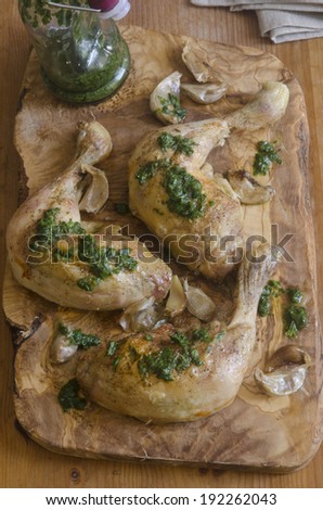 Roasted garlic and rocket chicken on a wooden board