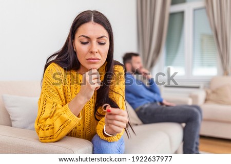 Stressed wife holding her wedding ring worried about breakup or divorce, avoid talking with husband after fight, anxious couple ignore each other. Frustrated sad wife taking off the wedding ring Royalty-Free Stock Photo #1922637977