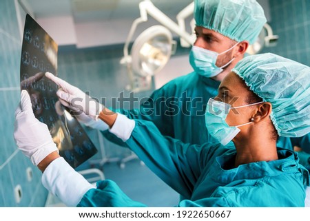 Portrait of intellectual healthcare professionals with at x-ray radiographic image, ct scan, mri Royalty-Free Stock Photo #1922650667