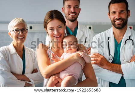 Portrait of happy mother with baby, medical pediatrician doctors, nurse