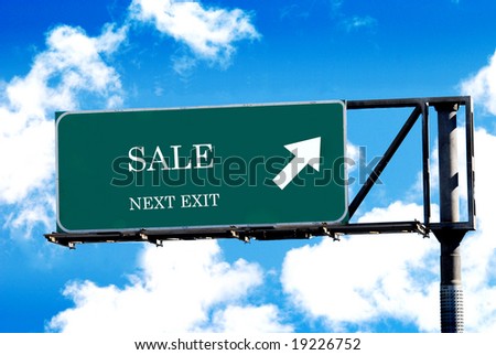sale sign on freeway signpost and blue sky