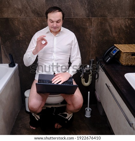 Male businessman showing approving gesture okay, work without pants in home toilet. Funny chatting online from home during the corona virus pandemic, concept