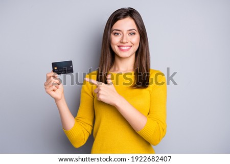 Portrait of lovely glad cheerful girl holding in hands demonstrating bank card solution isolated over grey color background Royalty-Free Stock Photo #1922682407