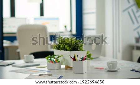 Interior of modern open plan financial office with no people, stylish room interior with meeting table and chairs. Business center with brainstorm area, shot of empty room with modern furniture.