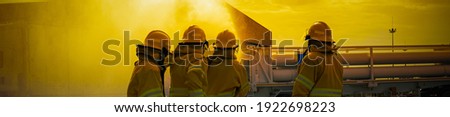 Fireman in the training session of emergency to recovery and fighting fire case picture on yellow background