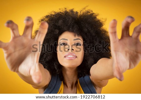 Self-portrait of a beautiful young African-American woman making a peace sign. Selfie concept.
