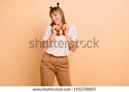 Photo portrait of girl enjoying listening music orange earphones stylish outfit isolated on pastel beige color background