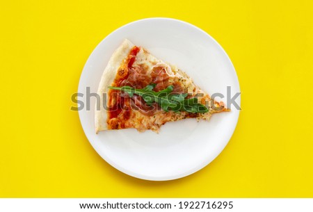 Pices of Pizza on white plat on yellow background. Royalty-Free Stock Photo #1922716295