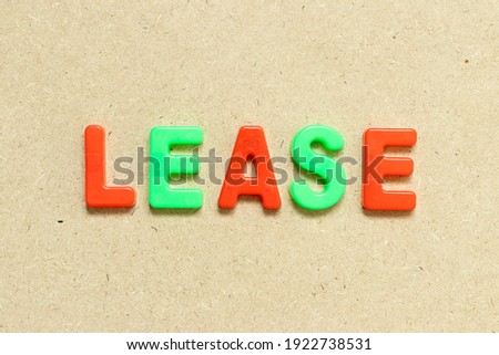 Color alphabet letter with word lease on wood background