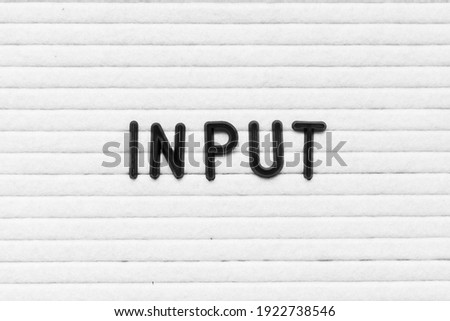 Black color letter in word input on white felt board background