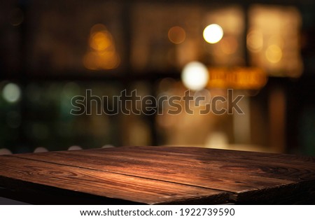 empty table to showcase your product, against the background of a blurred cafe golden bokeh Royalty-Free Stock Photo #1922739590