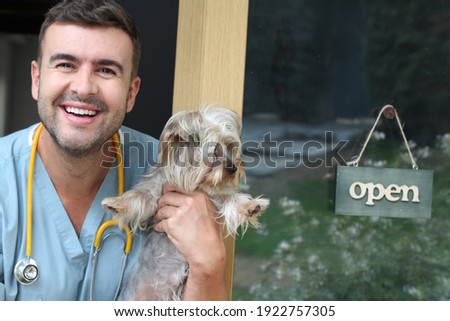 Cheerful veterinary with open sign