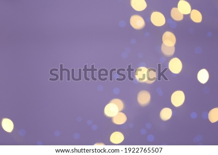 Beautiful blurred lights on violet background, bokeh effect. Space for text