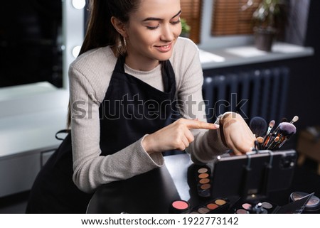 Vlogger and blogger freelance job, make up concept. Happy, young ,caucasian woman recording live video for vlog and social media with smartphone, beauty salon, office background. High quality photo