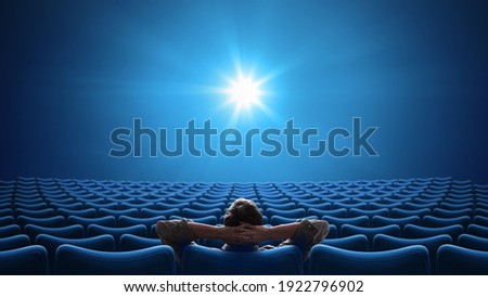 Cinema with person sitting in center 16:9 format