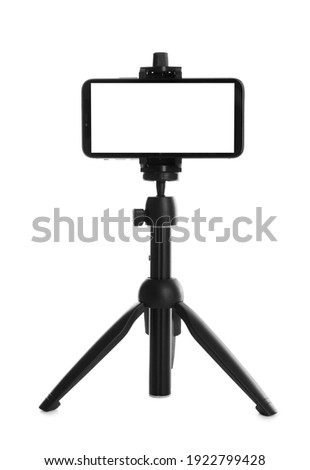 Smartphone with blank screen fixed to tripod on white background, mockup for design Royalty-Free Stock Photo #1922799428