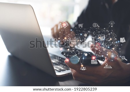 IoT, Internet of Things, digital software technology, metaverse, Ai Artificial Intelligence, data transfer, cloud computing and digital marketing concept. Man using smartphone and laptop computer Royalty-Free Stock Photo #1922805239