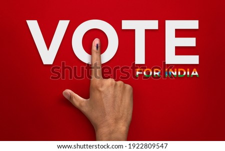 male Indian Voter Hand with voting sign or ink pointing vote for India on red background with copy space election commission of India Royalty-Free Stock Photo #1922809547
