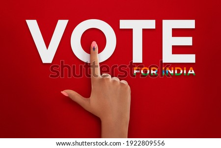 female Indian Voter Hand with voting sign or ink pointing vote for India on red background with copy space election commission of India Royalty-Free Stock Photo #1922809556