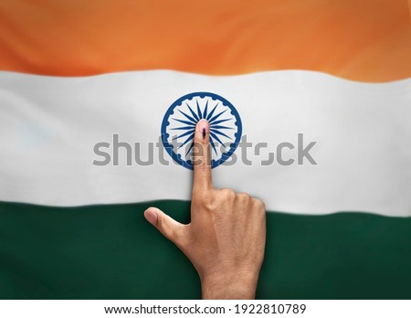 female Indian Voter Hand with voting sign or ink pointing vote for India on india flag background commission of India Royalty-Free Stock Photo #1922810789
