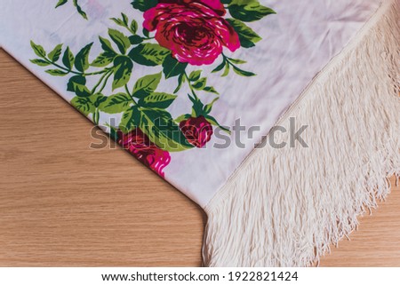 A white manila shawl with a red rose floral print. Concept of traditional typical dance of spain, flamenco