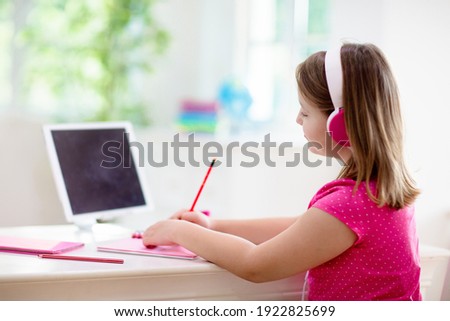 Online remote learning. School kids in earphones with computer having video conference chat with teacher and class group. Child studying from home. Homeschooling in quarantine and coronavirus outbreak