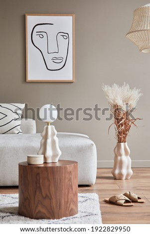 Stylish interior with design neutral modular sofa, mock up poster frames, coffee tables, table lamp, ceramic vessel, decoration, slippers and elegant personal accessories in modern home decor Template