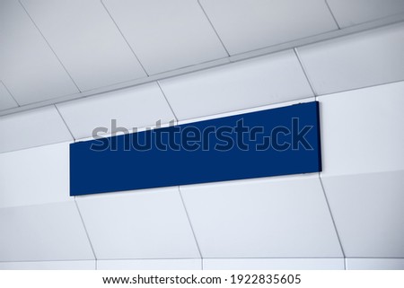 minimalist blue color blank sign in the subway terminal, to put your texts or logo