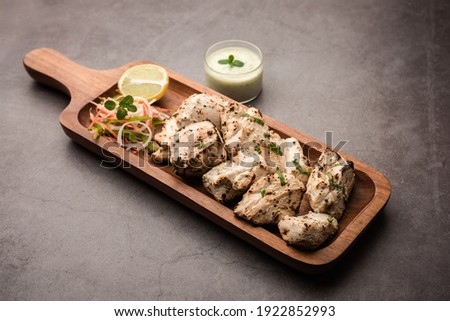 Indian Afghani chicken Malai Tikka is a grilled Murgh creamy kabab served with fresh salad Royalty-Free Stock Photo #1922852993