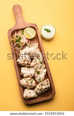 Indian Afghani chicken Malai Tikka is a grilled Murgh creamy kabab served with fresh salad Royalty-Free Stock Photo #1922853056
