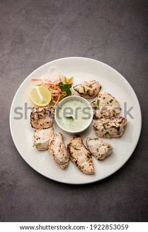 Indian Afghani chicken Malai Tikka is a grilled Murgh creamy kabab served with fresh salad Royalty-Free Stock Photo #1922853059
