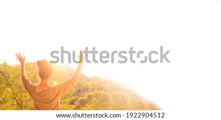 Woman raised hands up on top of mountain and sunset banner background.Freedom, Pray, Holy spirit, Good friday, Easter, Prayer, Praise the LORD.Blessed to the nation.Christian pentecost.peace, mind.