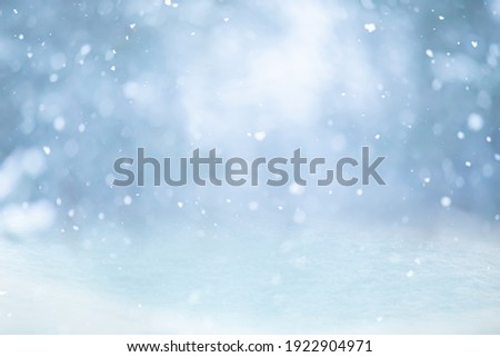 MAGICAL WINTER BACKGROUND WITH SNOW, SNOW FLAKES AND SOFT BOKEH LIGHTS ON BLUE SKY, COLD BACKDROP FOR CHRISTMAS, SNOWY STILL LIEFE AT FROSTY WEATHER TIME Royalty-Free Stock Photo #1922904971