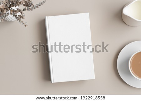 White book mockup with a lavender, coffee and a bottle of a milk on a beige table. Royalty-Free Stock Photo #1922918558