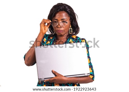 beautiful adult business woman holding a laptop and wearing her optical glasses.