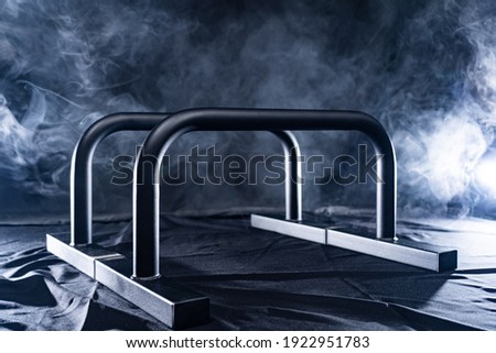 gymnastic bars for push-ups isolated on back and smoked background