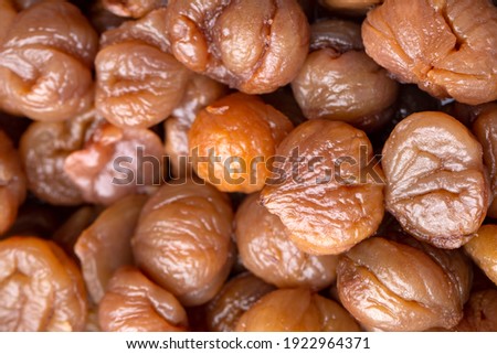 Chestnut dessert and chestnuts on a plate. Traditional delicious Turkish dessert; chestnut candies (Kestane Sekeri) Royalty-Free Stock Photo #1922964371