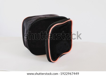 Small black pocket bag on white background.
