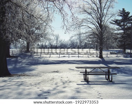 Picnic table on frozen, snowy pond