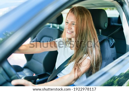 Young beautiful blonde woman smiling happy driving car Royalty-Free Stock Photo #1922978117