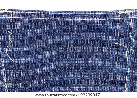 Part of blue denim jeans back pocket isolated on white background.