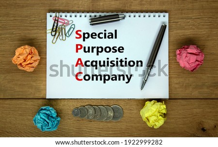 SPAC, special purpose acquisition company symbol. White note with words 'SPAC' on beautiful wooden background, copy space. Business and SPAC, special purpose acquisition company concept.